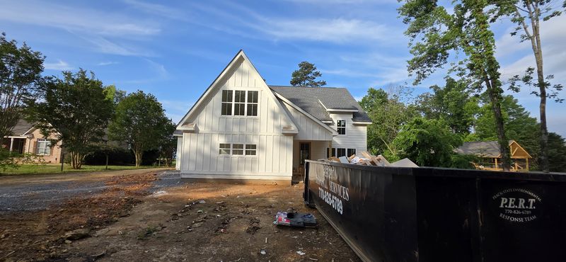 White new-build home exterior at a construction stage — Diaz project