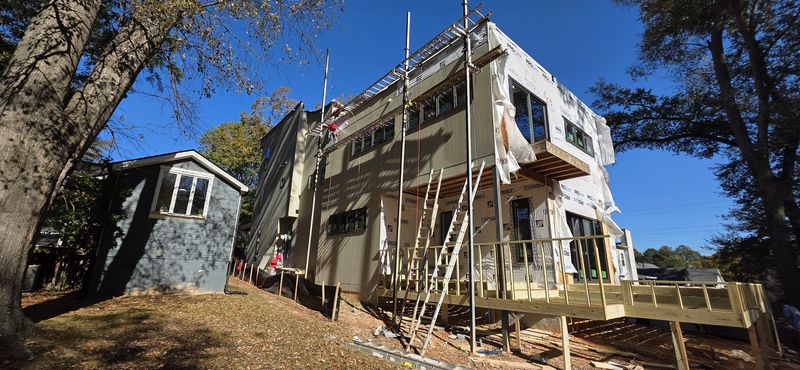 Home under construction with wrapped openings — Diaz exterior work in progress