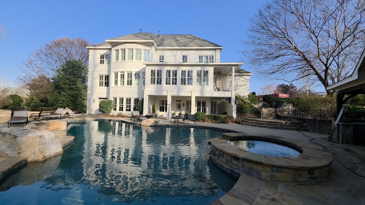 White two-story home with a pool terrace — exterior project by Diaz Signature Exteriors