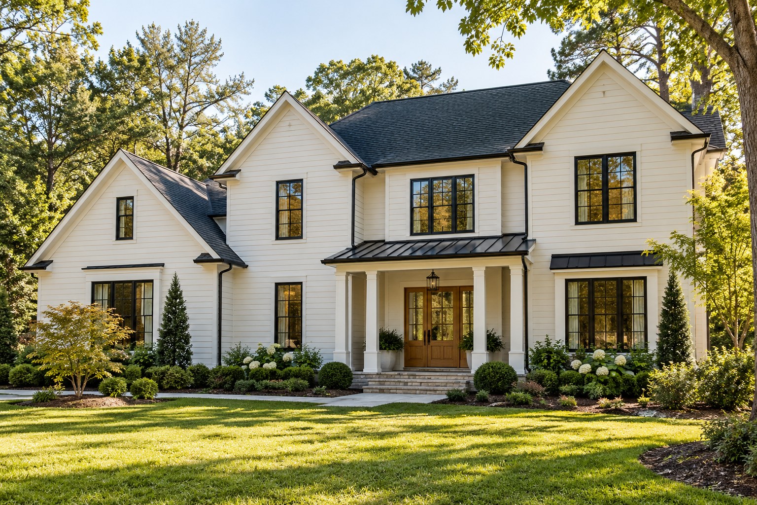 Welcoming ivory home with black windows and a warm wood entry, shown as design inspiration